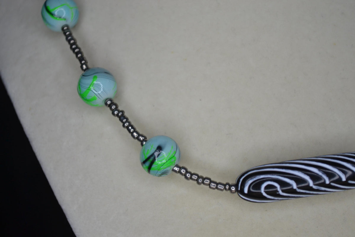 Multicolor glass and wood bead necklace. Metallic grey, tie dye, and black & white stripes