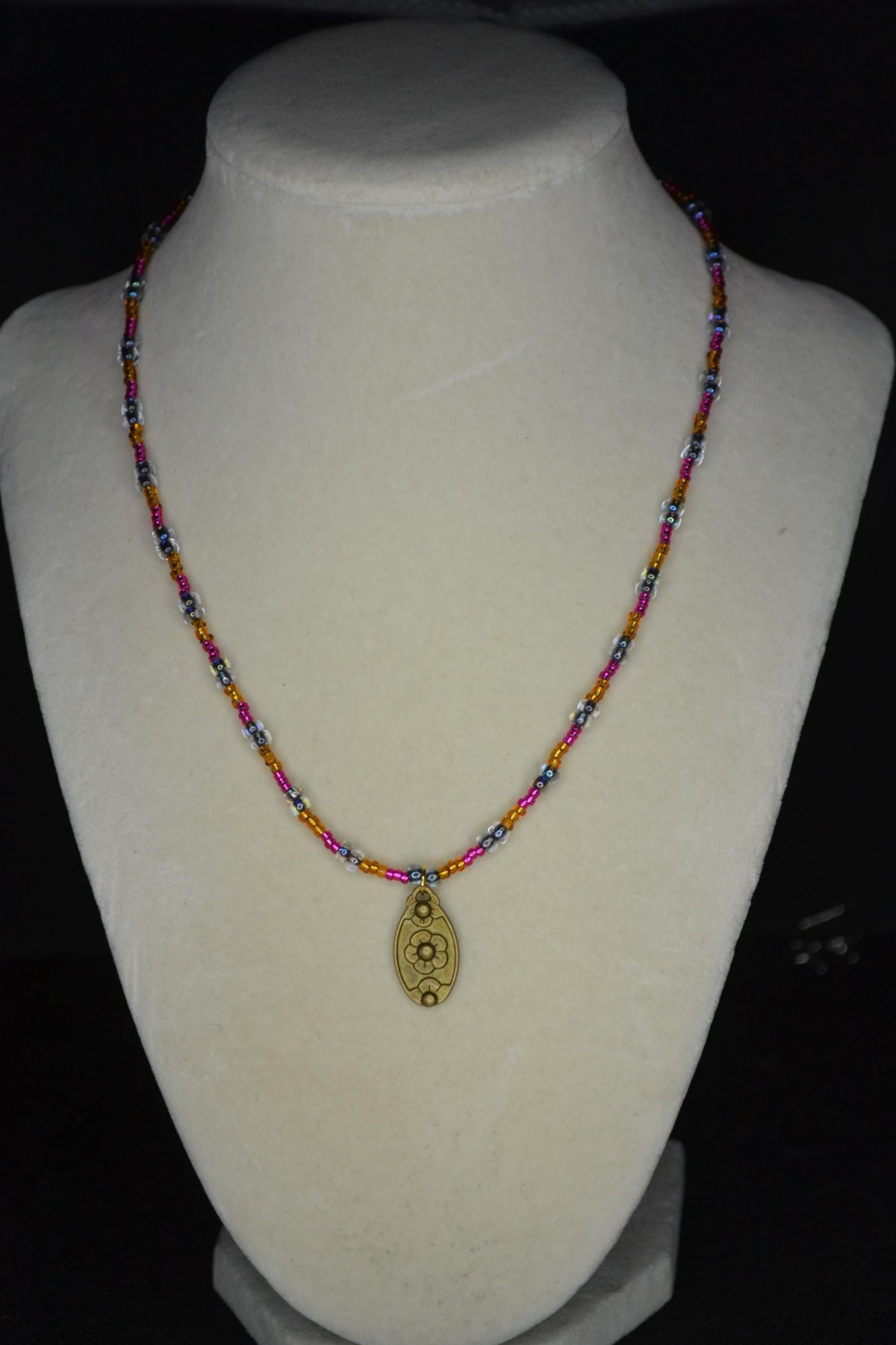 Bronze gold flower pendant glass bead necklace. Brown, Fuschia, and black