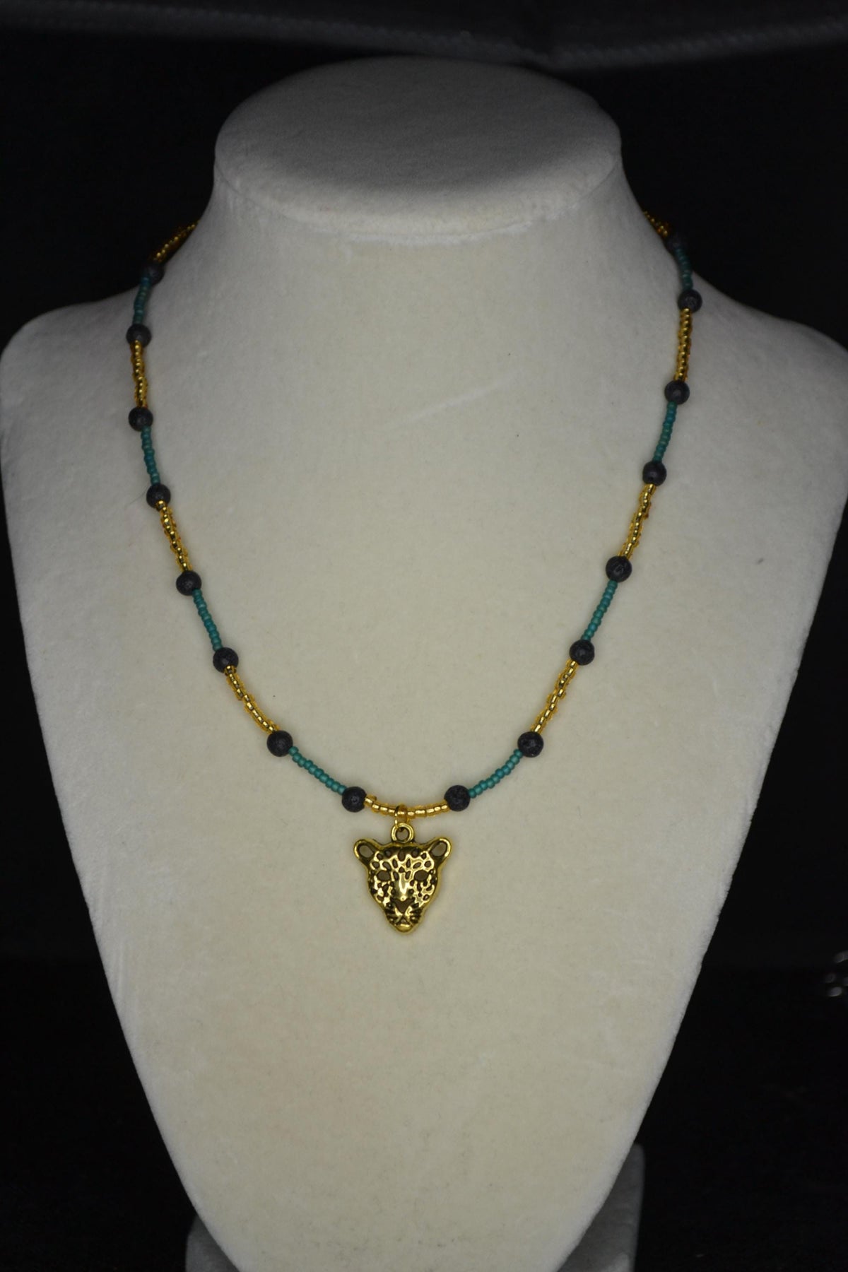 Gold Jaguar pendant glass bead necklace. Teal, gold, and lava rock