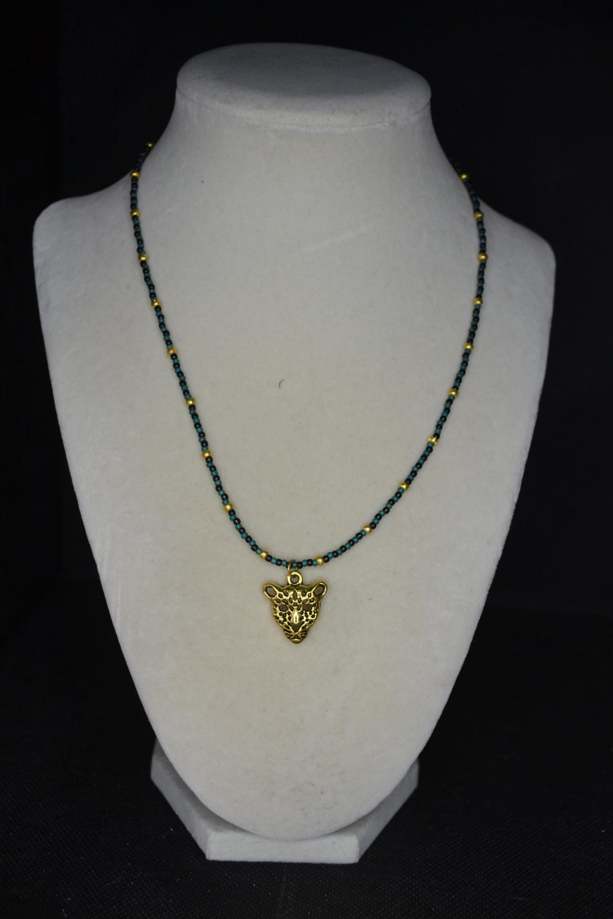 Gold Jaguar pendant glass bead necklaces. Teal, black, and gold