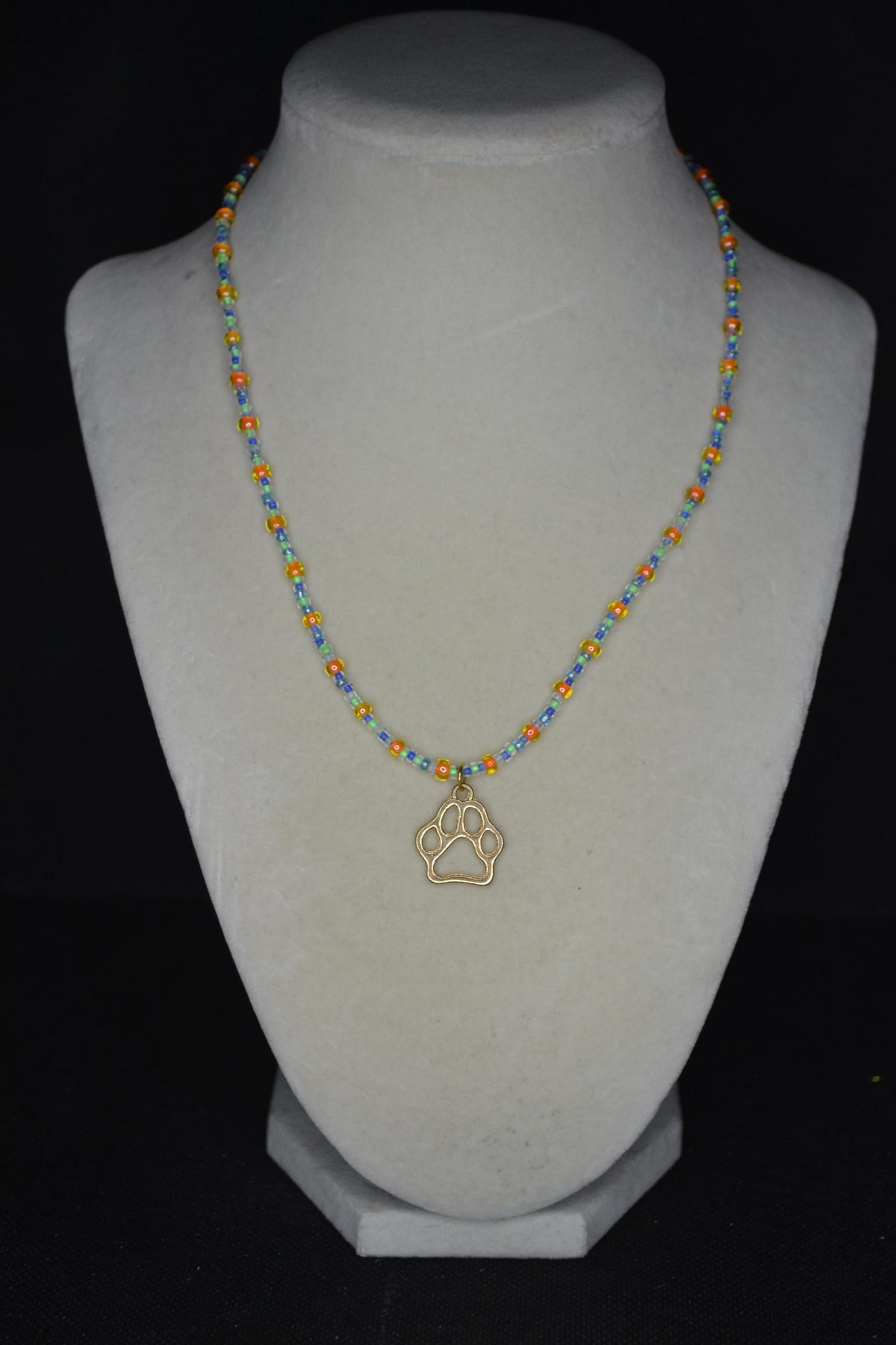 Gold Paw print pendant glass bead necklace. Orange, green, and blue
