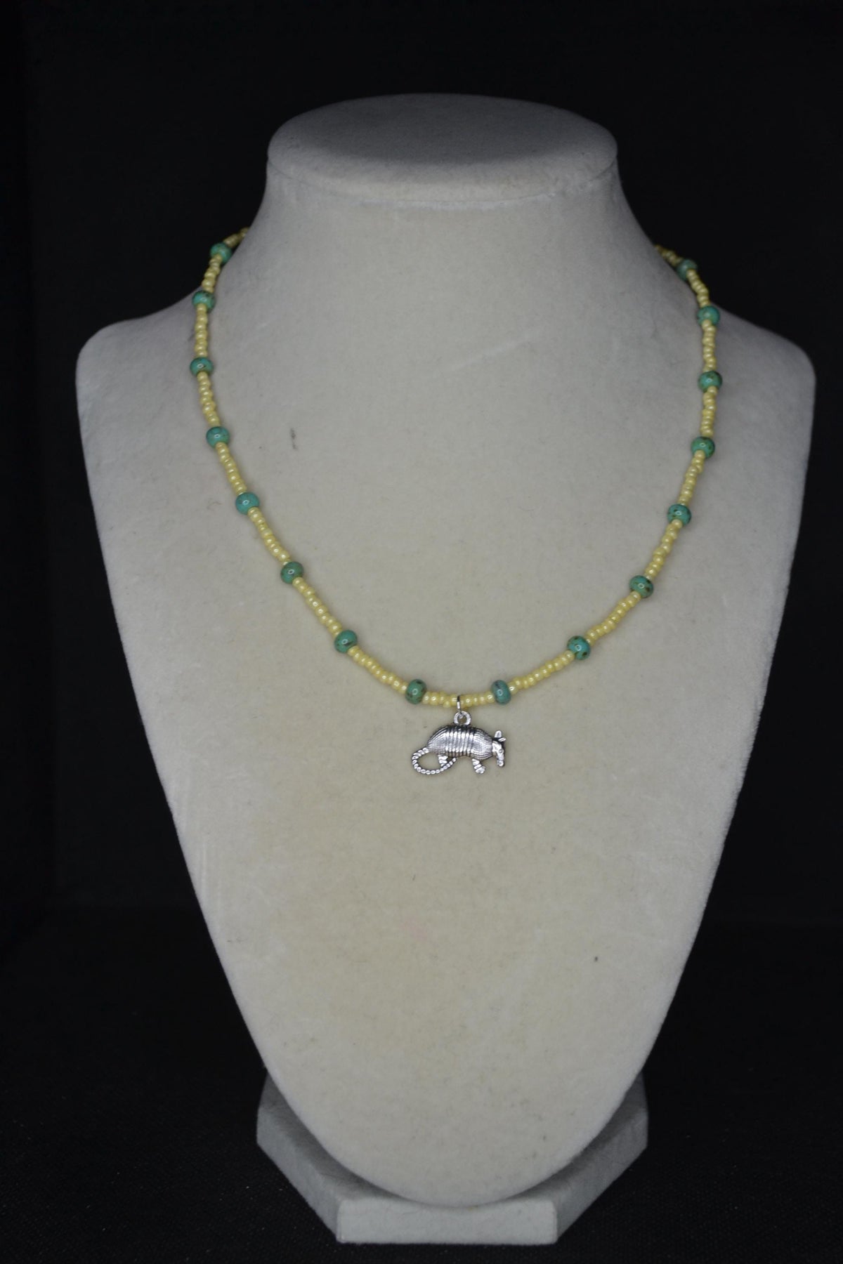 Silver Armadillo pendant glass bead necklace. Yellow and turquoise