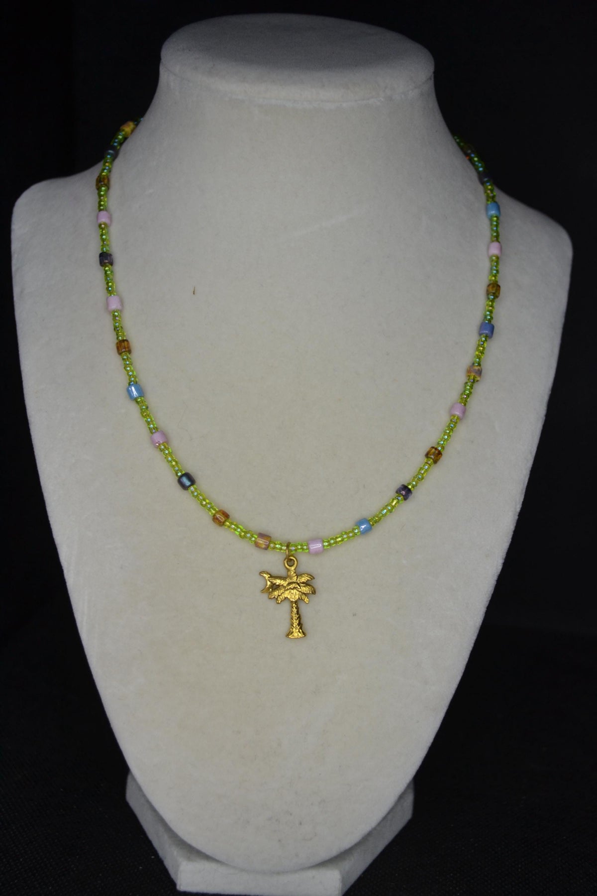 Gold Palm pendant glass bead necklace. Green and rainbow