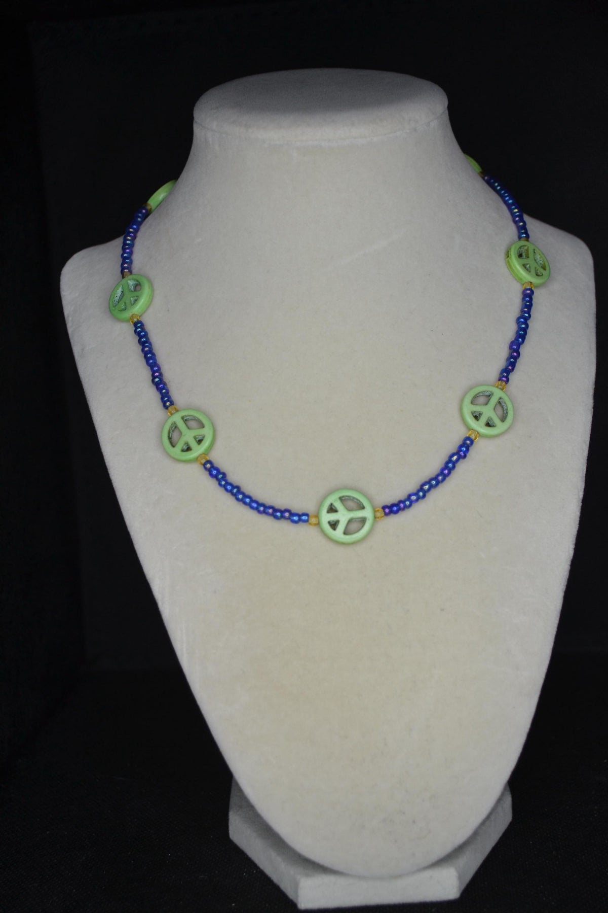 Multicolor glass bead necklace. Green peace sign, blue, and amber