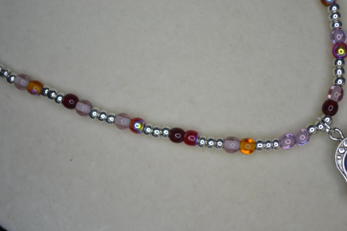 Silver Hamsa pendant glass bead necklace. Reds, silver, lavender, and orange