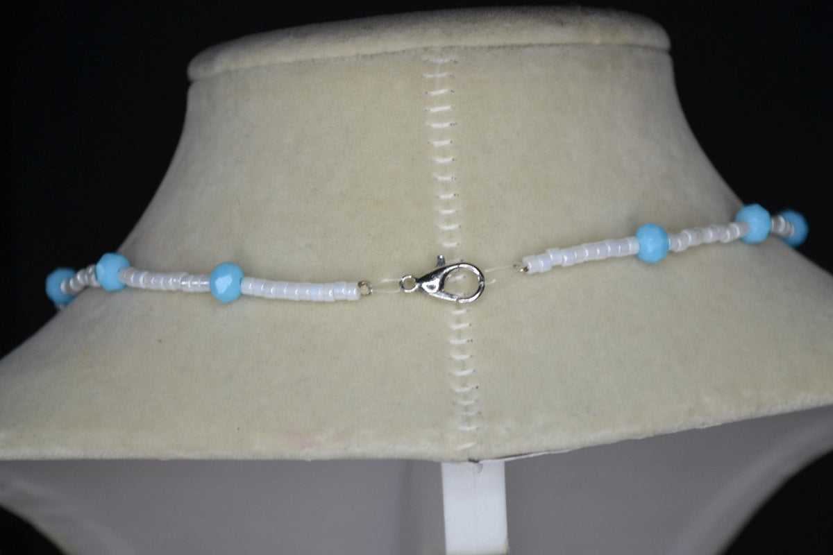 Silver crab pendant glass bead necklace. Blue and white