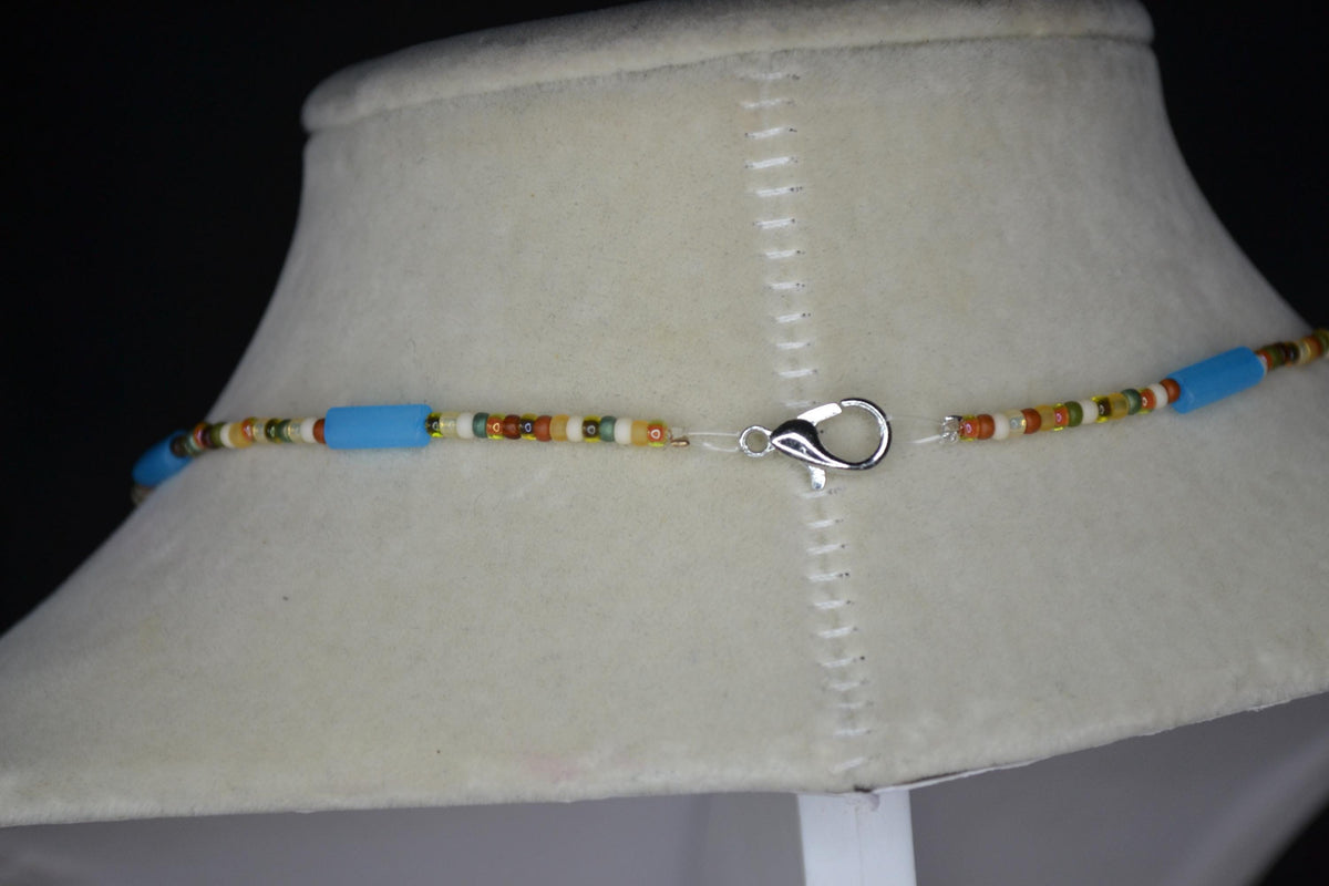 Silver sun pendant glass bead necklace. Matte blue and forest colors