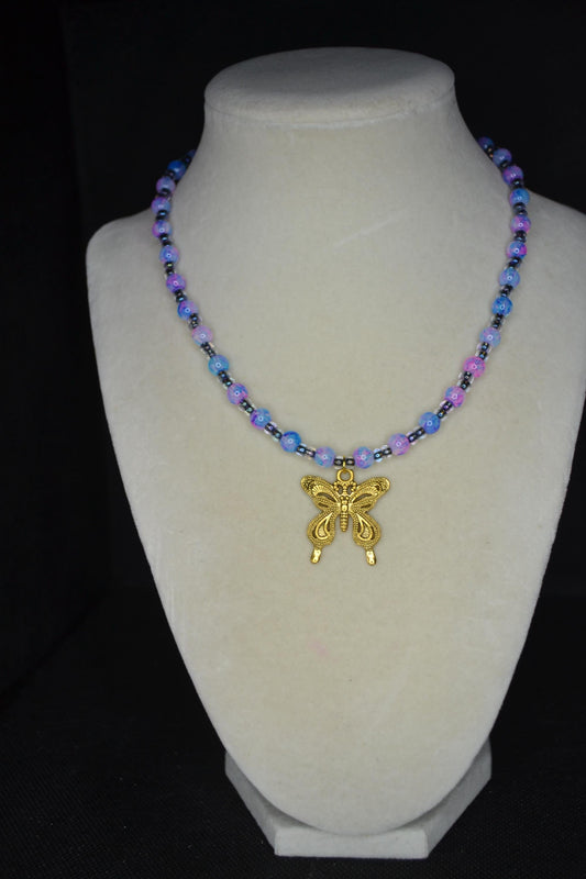 Gold Butterfly pendant glass bead necklace. Blue, pink, and black