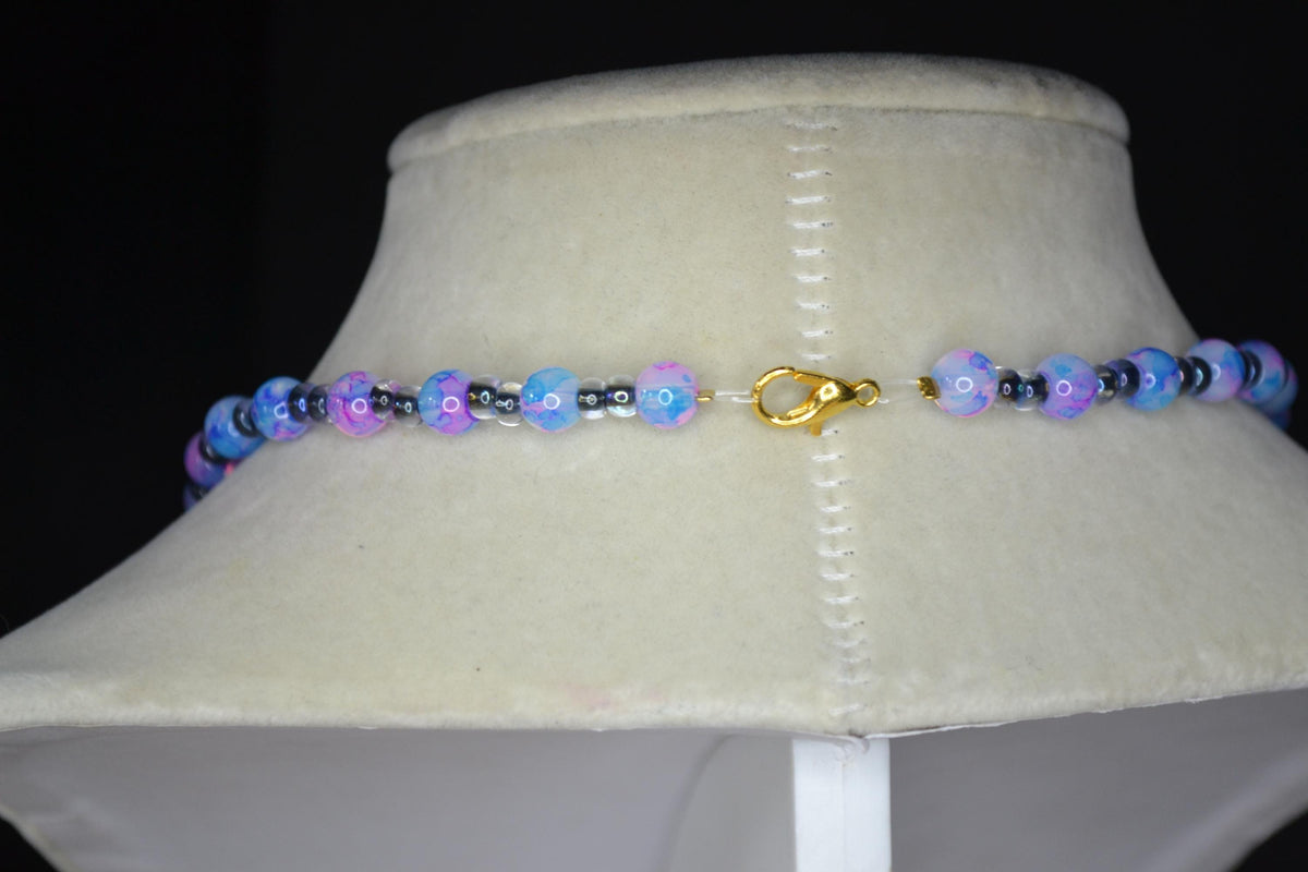 Gold Butterfly pendant glass bead necklace. Blue, pink, and black