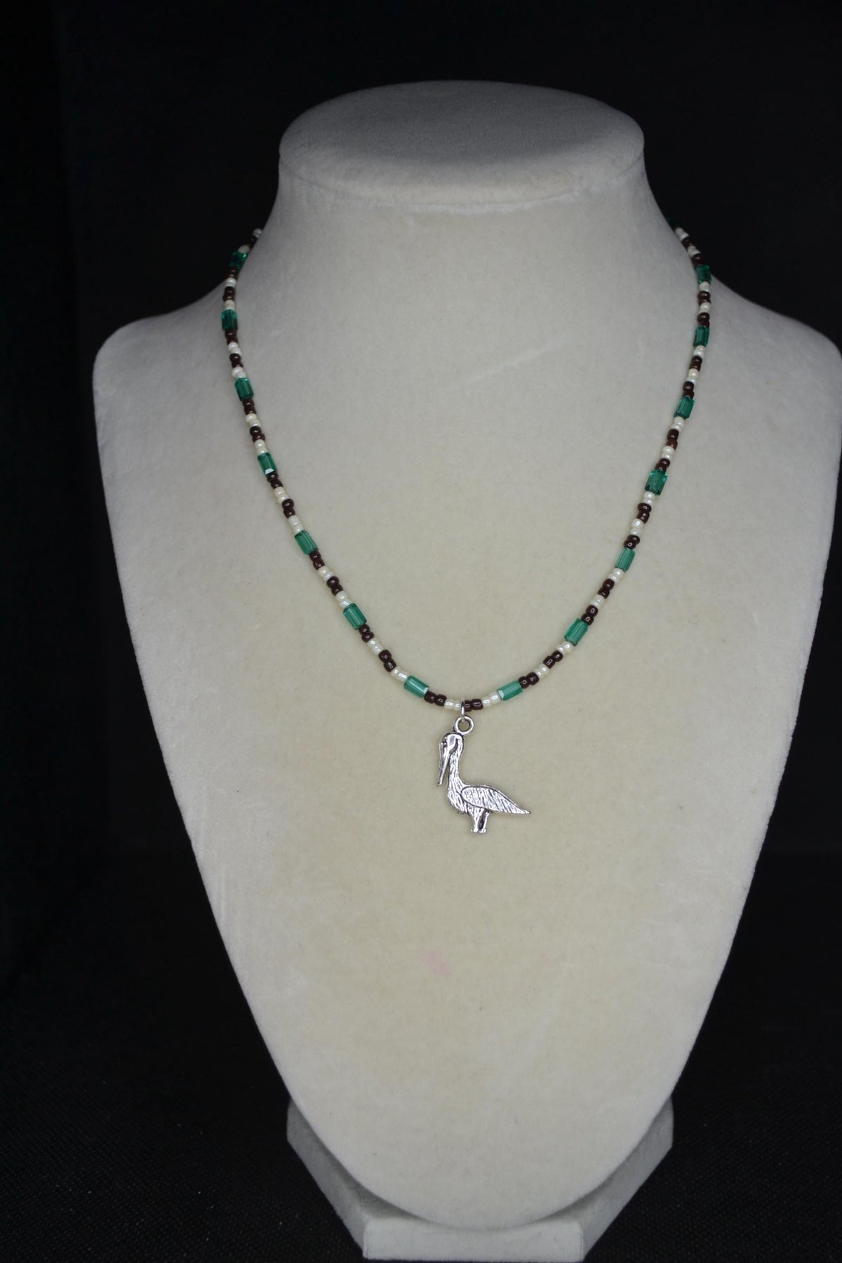 Silver Pelican pendant glass bead necklace. Teal, brown, and white