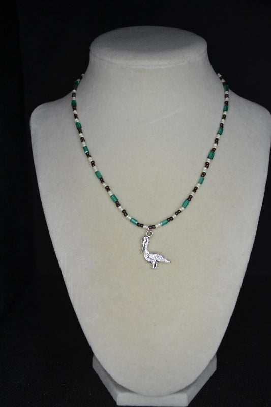 Silver Pelican pendant glass bead necklace. Teal, brown, and white