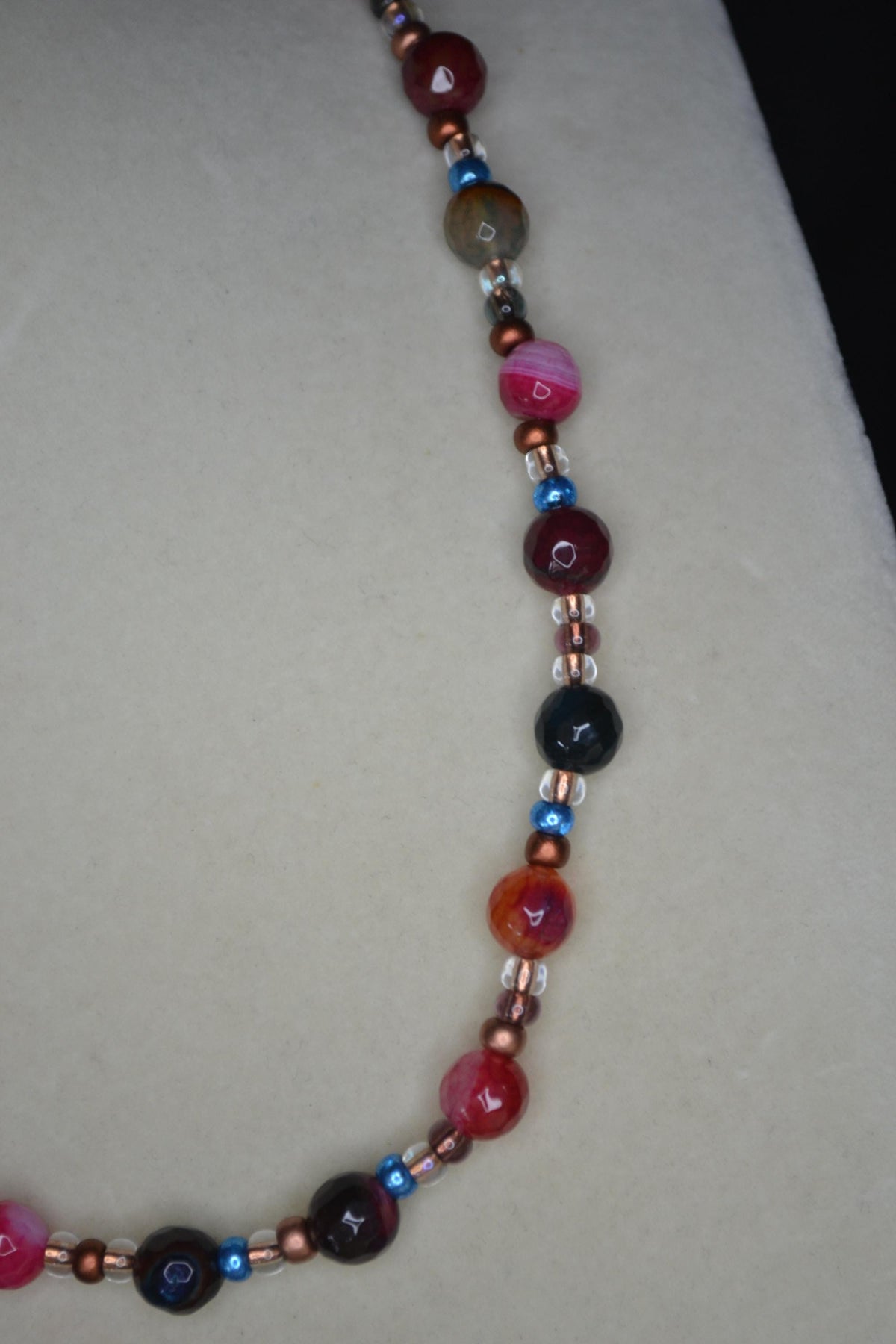 Multicolor glass beaded necklace. Reds, blues, and bronze
