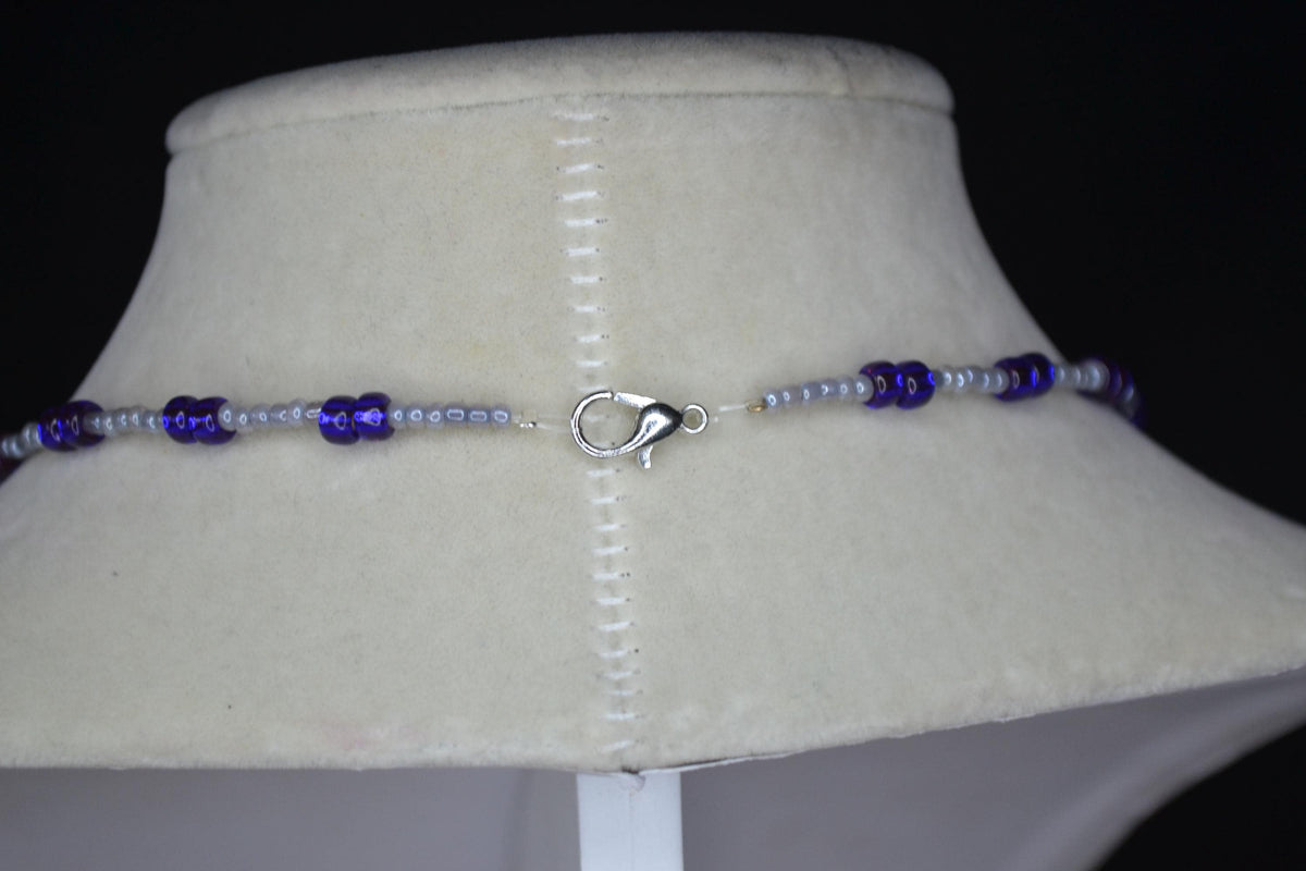 Silver Manatee pendant glass bead necklace. Pearl grey and iridescent indigo