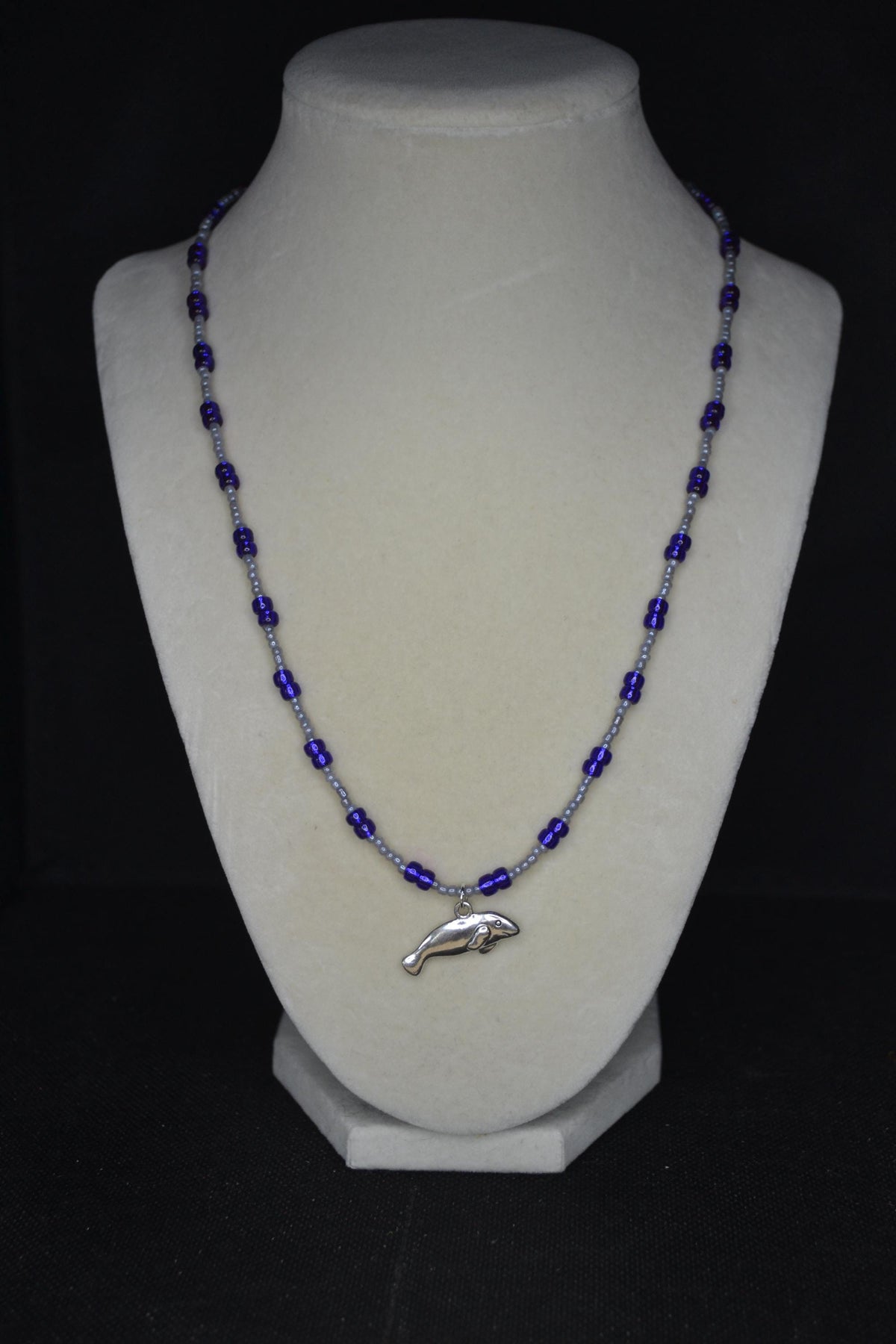 Silver Manatee pendant glass bead necklace. Pearl grey and iridescent indigo
