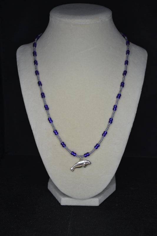 Silver Manatee pendant glass bead necklace. Pearl grey and iridescent indigo