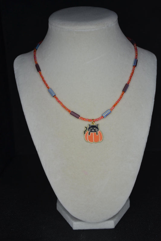 Black cat in pumpkin pendant glass bead choker. Orange and metallic amethyst