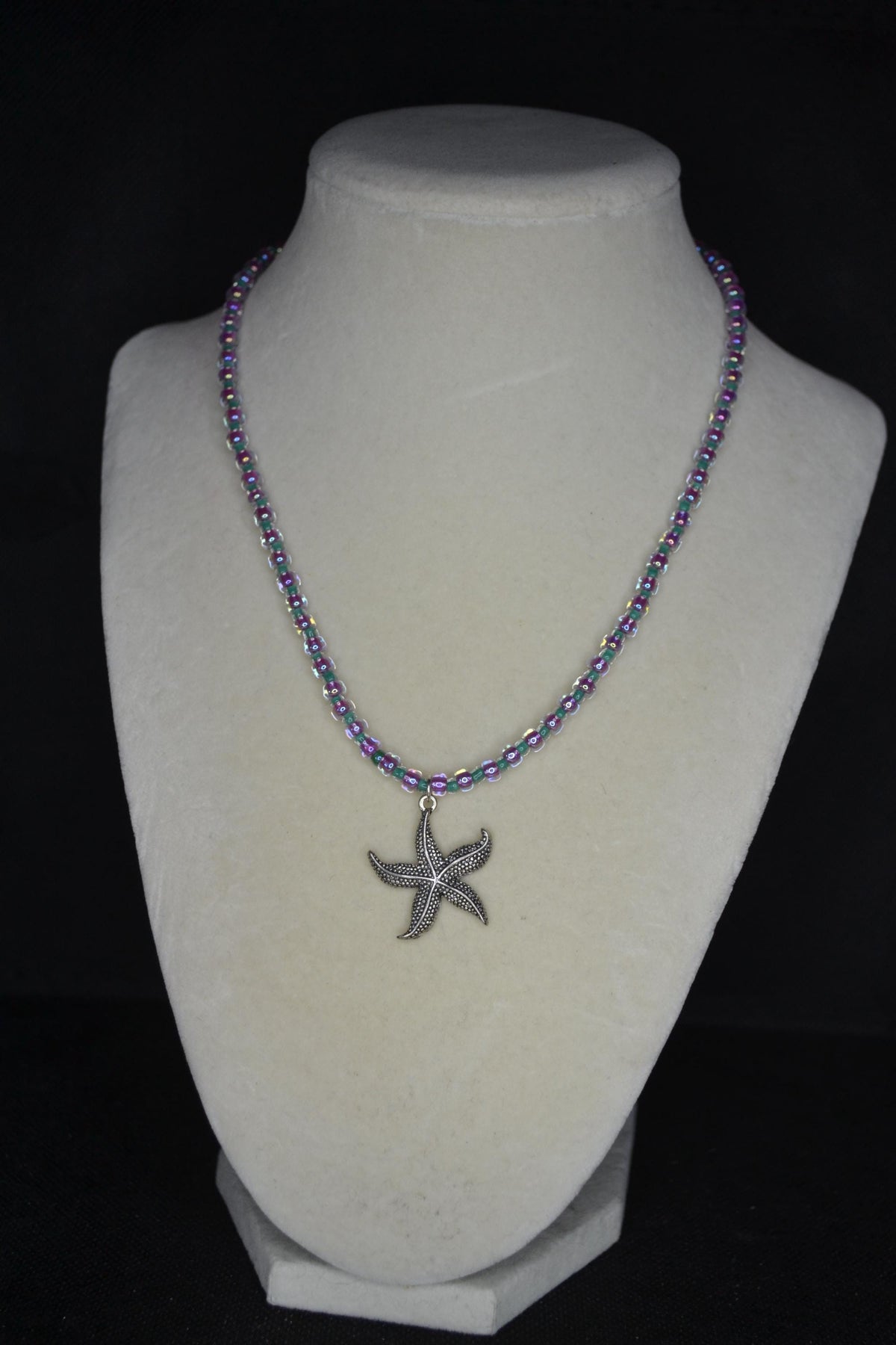Silver starfish pendant glass bead necklace. Teal and iridescent pink
