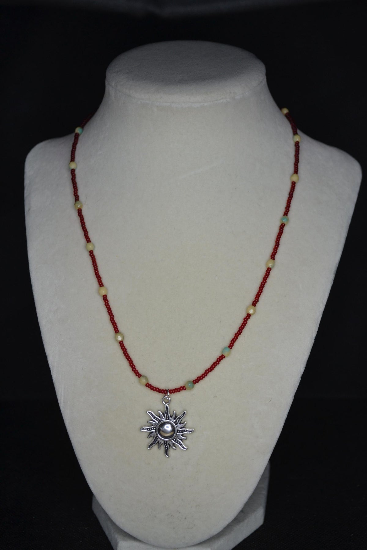 Silver Sun pendant glass bead necklace. Red, cream, and teal