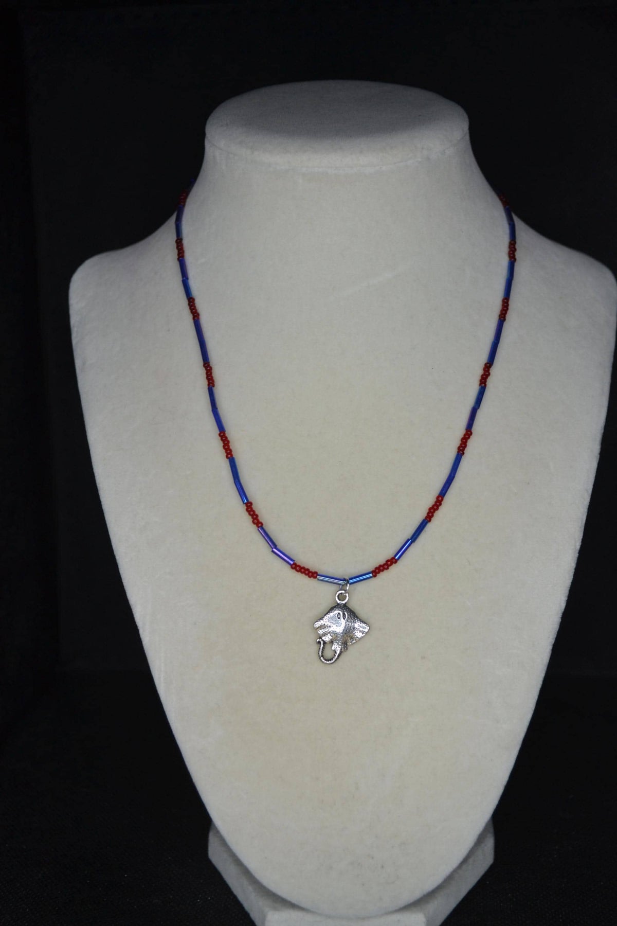 Silver Stingray pendant glass bead necklace. Red and blue
