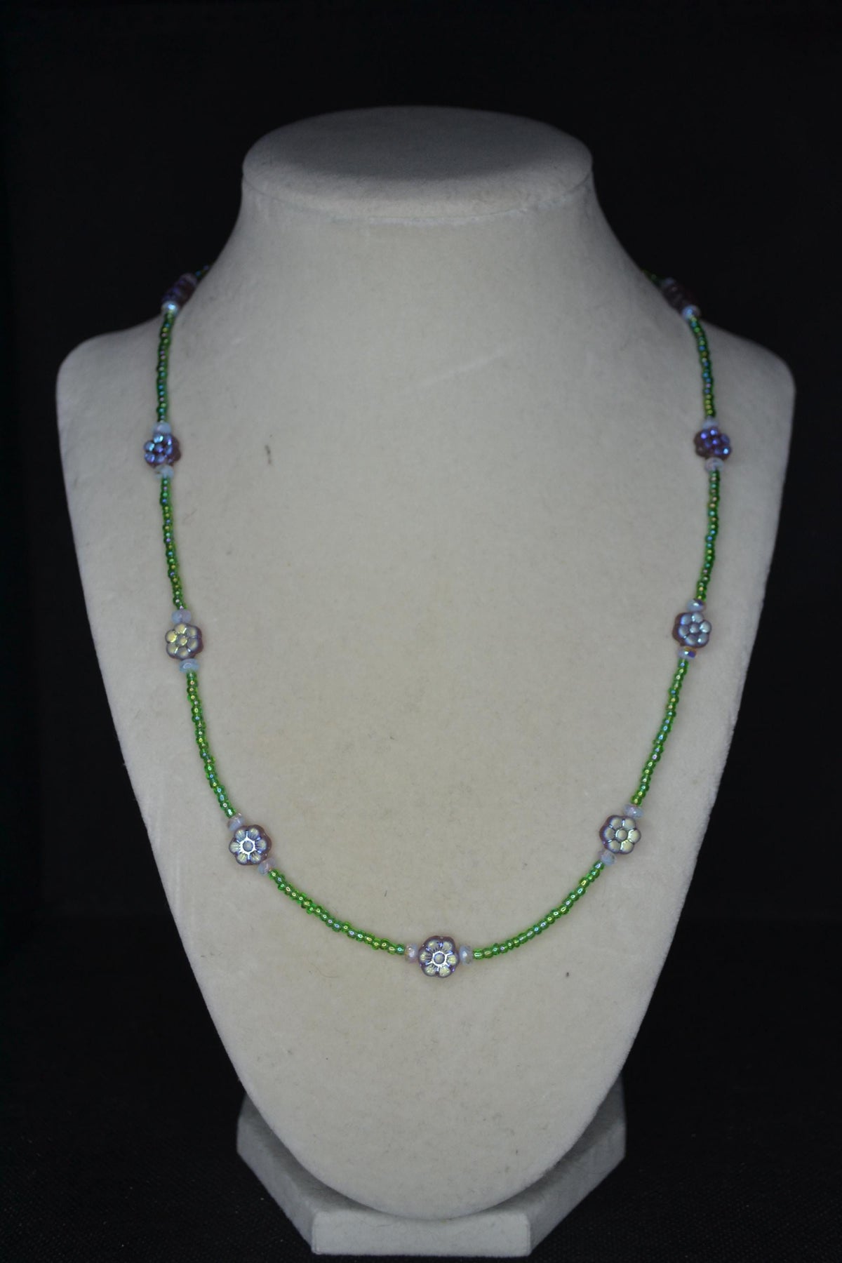 Beaded flower glass necklace. Iridescent purple, green, and sky blue. Reversible