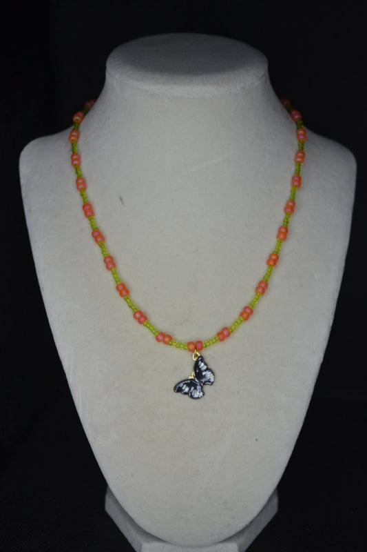 Black butterfly pendant glass bead necklace. Green and coral