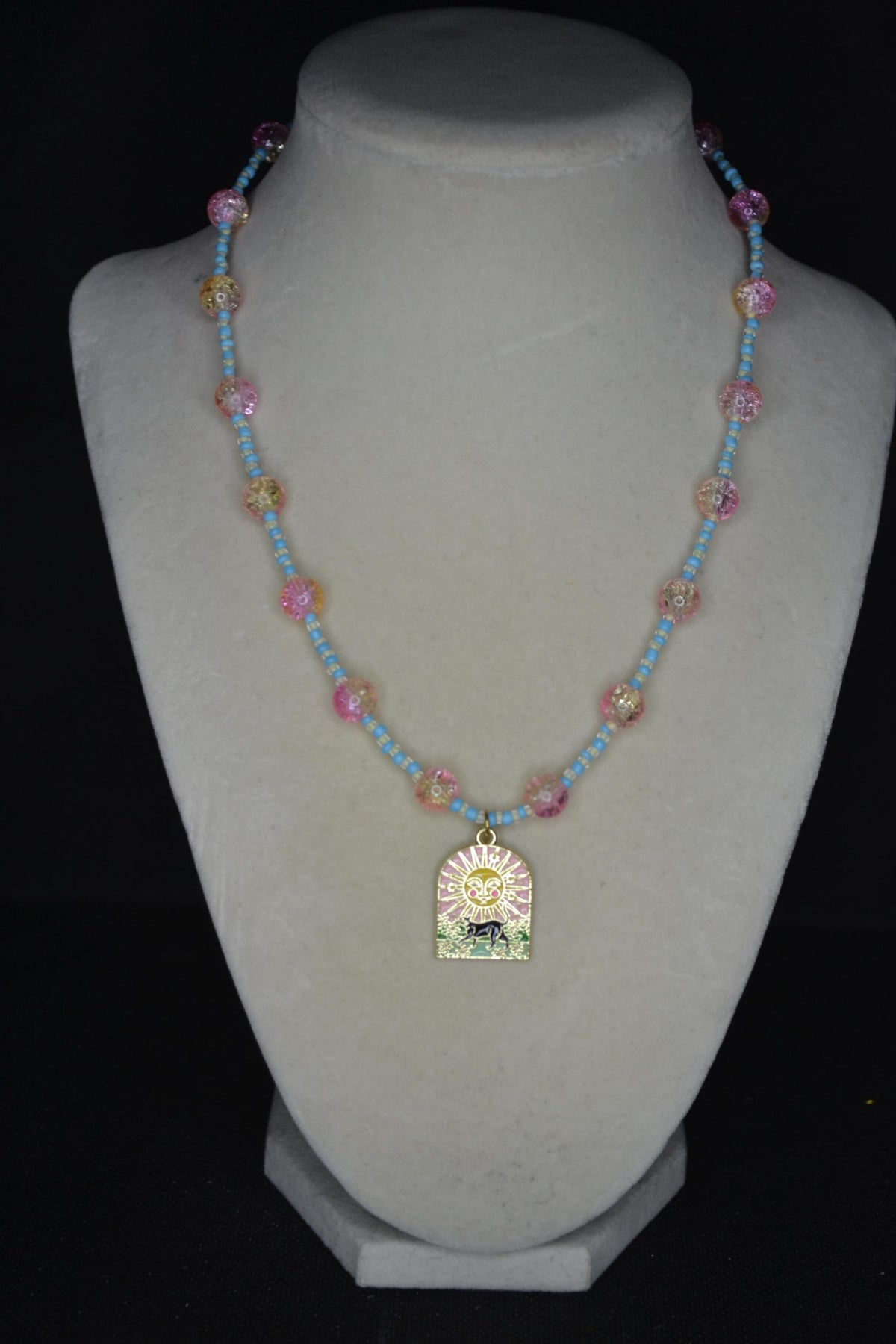 Black cat & sun pendant glass bead necklace. Blue, white, yellow, and pink