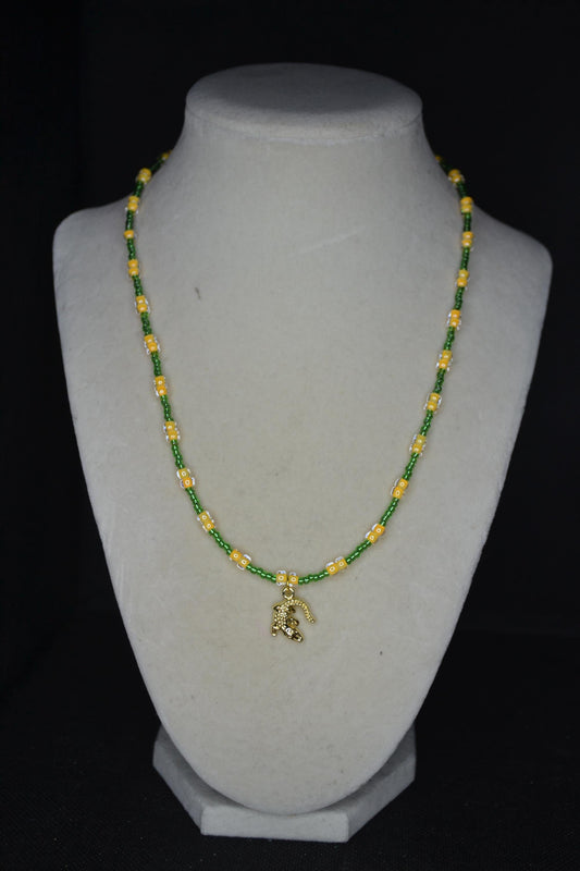 Gold alligator pendant glass bead necklace. Green and yellow