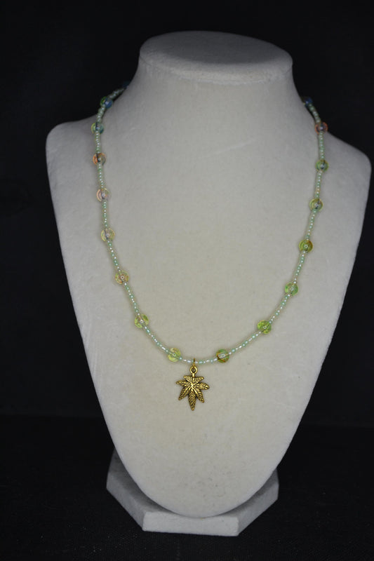 Gold Marijuana Leaf pendant glass bead choker. Pearl white, green, and topaz