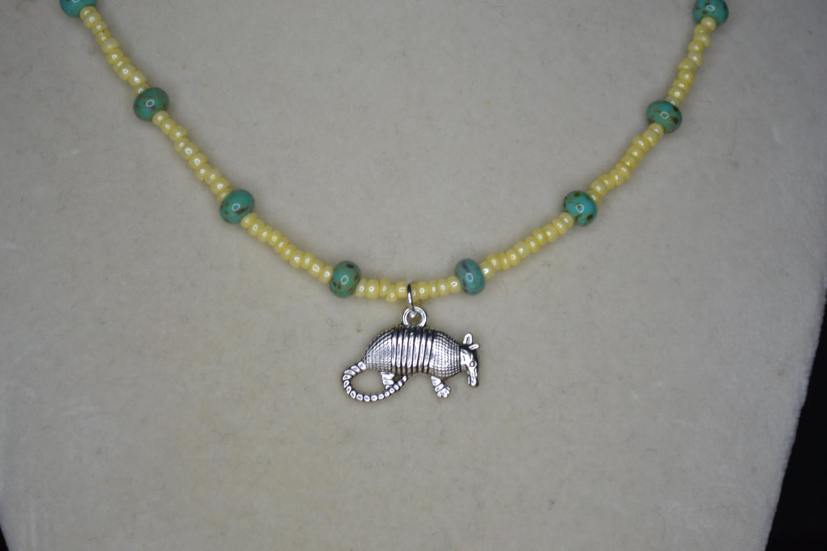 Silver Armadillo pendant glass bead necklace. Yellow and turquoise