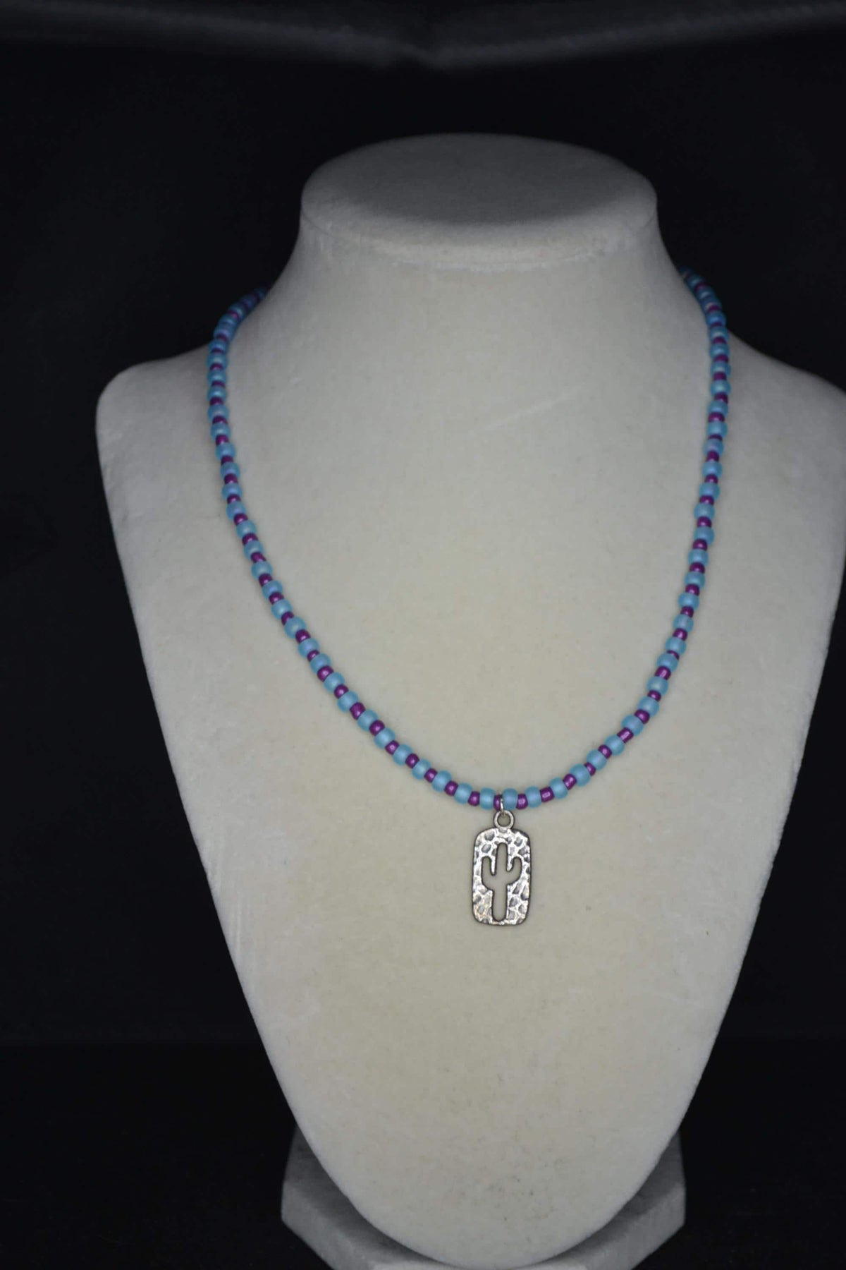 Silver Hammered cactus pendant glass bead necklace. Blue and purple