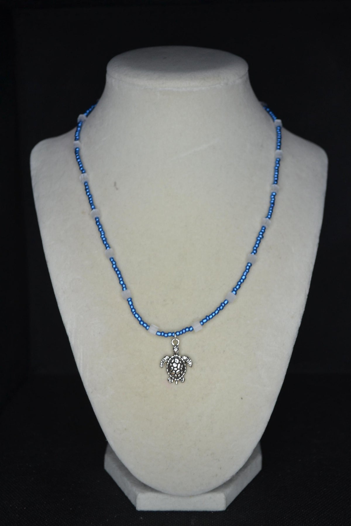 Silver Turtle pendant glass bead necklace. Metallic blue and cat eye