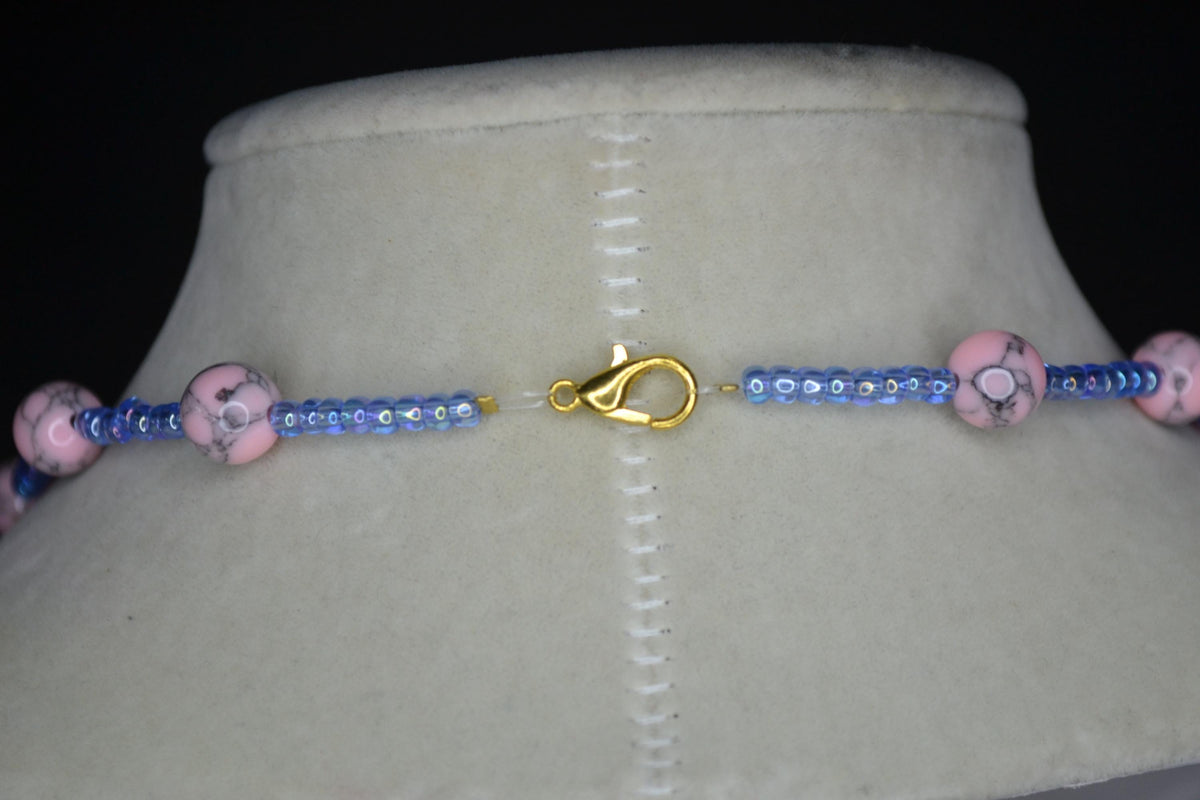 Beaded Cross glass necklace. Pink turquoise, white, and blue