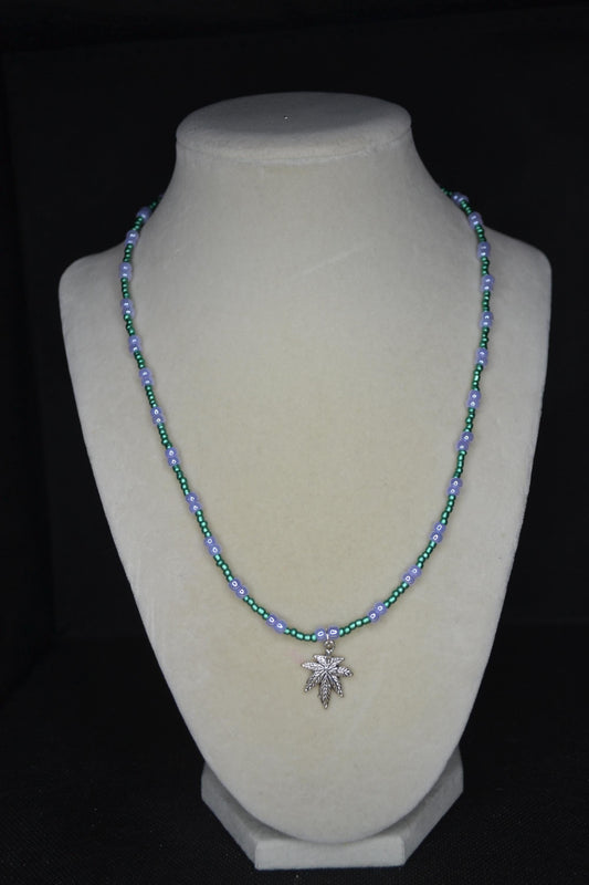 Silver marijuana pendant glass bead necklace. Metallic green and pearlescent lavender