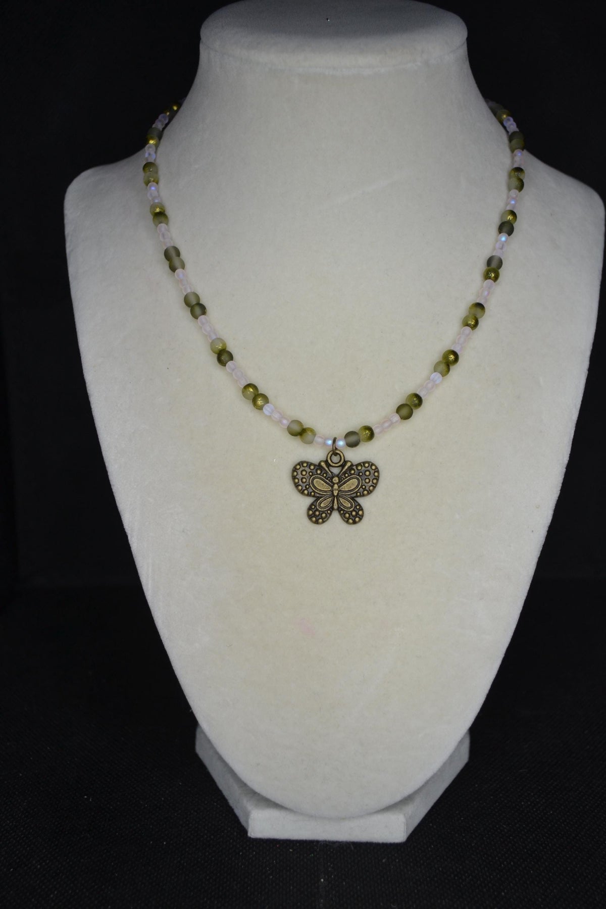 Bronze butterfly pendant glass bead necklace. Frosted pink and frosted green gold