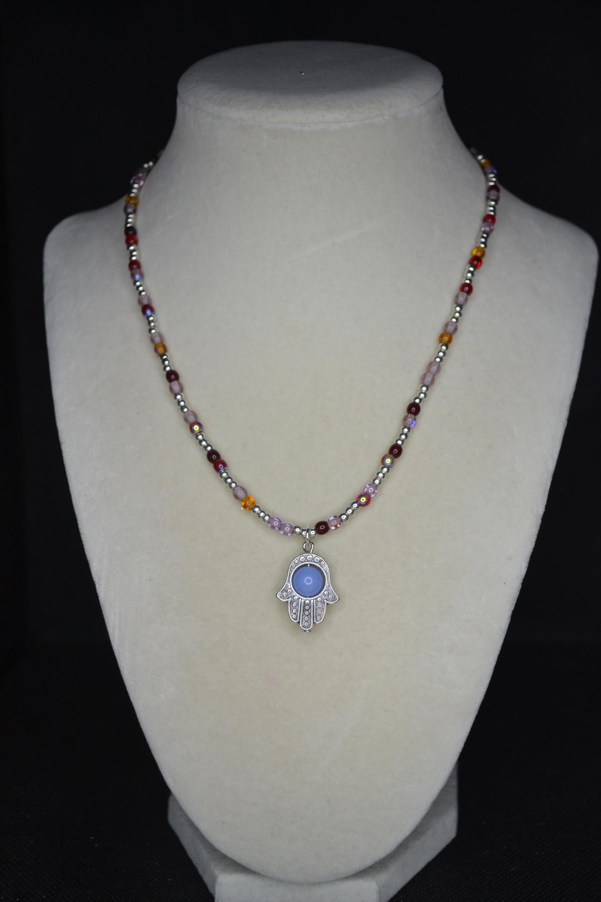 Silver Hamsa pendant glass bead necklace. Reds, silver, lavender, and orange