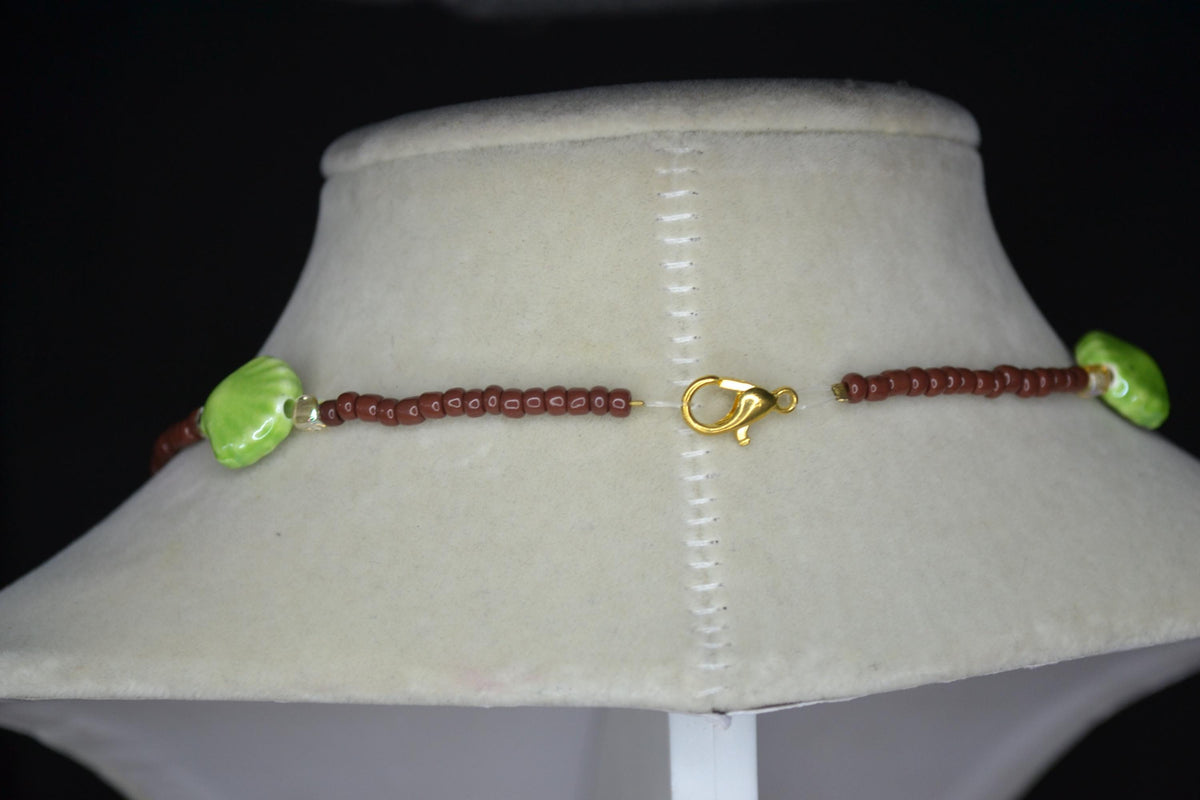Beaded Seashell Necklace. Green, brown, and metallic amber