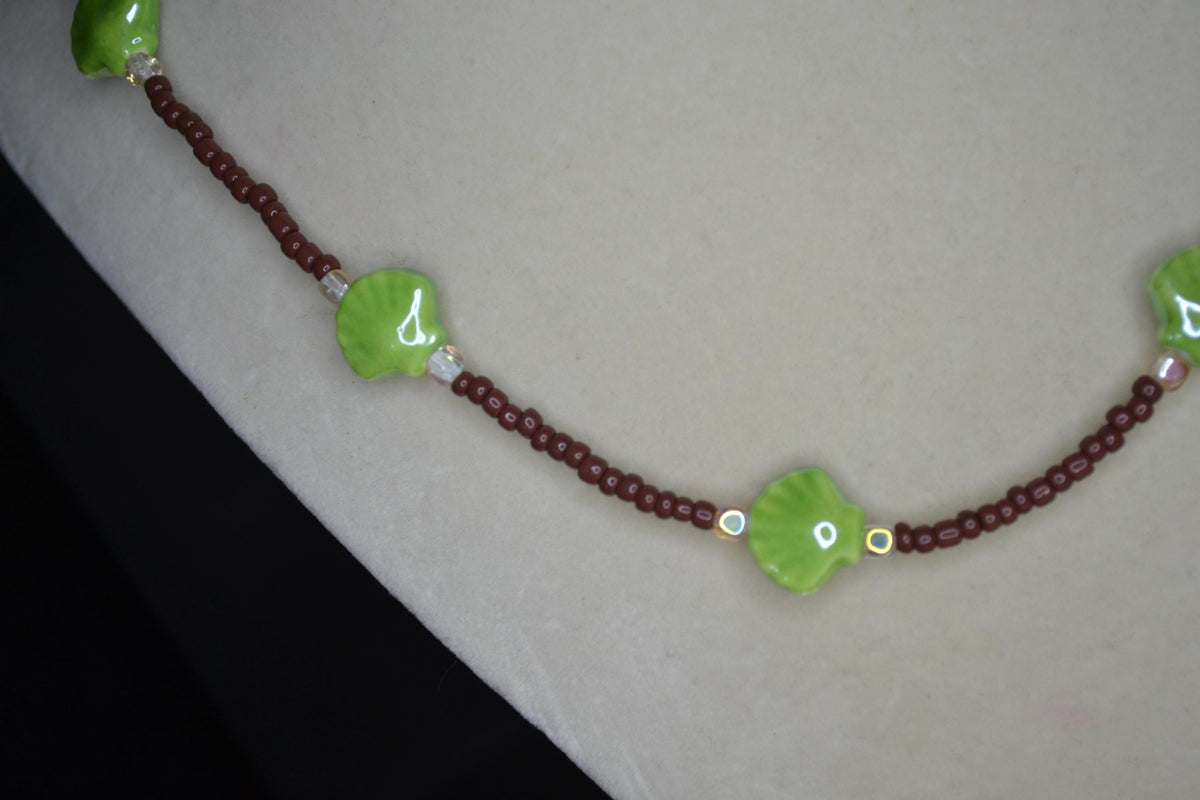 Beaded Seashell Necklace. Green, brown, and metallic amber