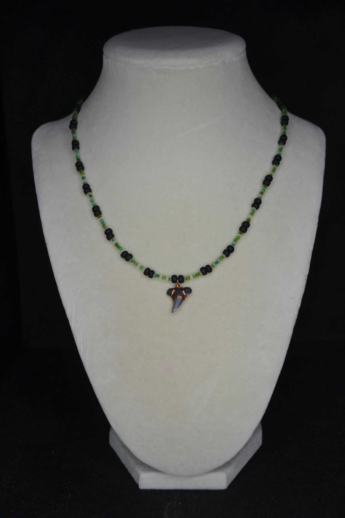 Wire wrapped sharks tooth beaded necklace. Frosted greens and matte black