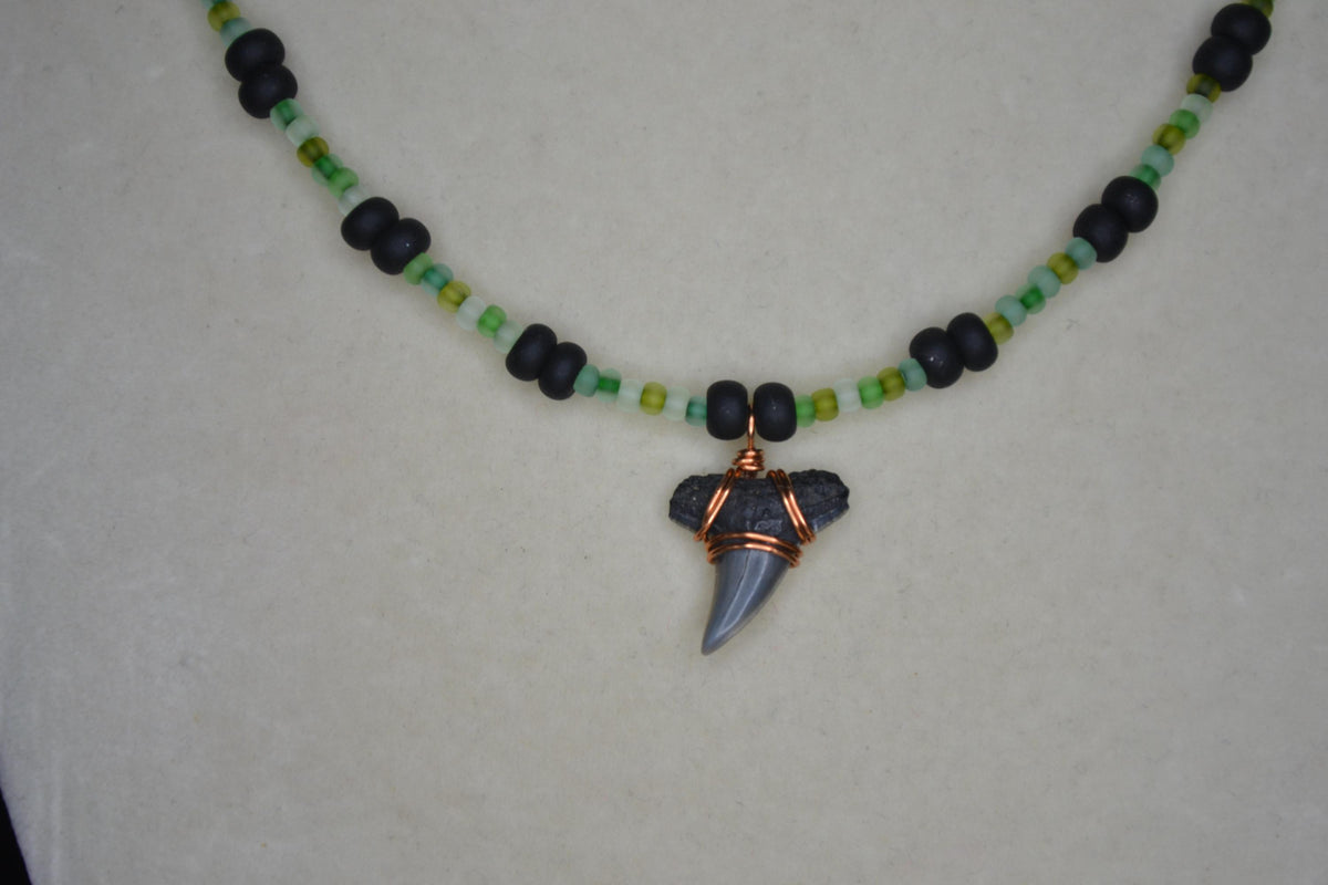 Wire wrapped sharks tooth beaded necklace. Frosted greens and matte black