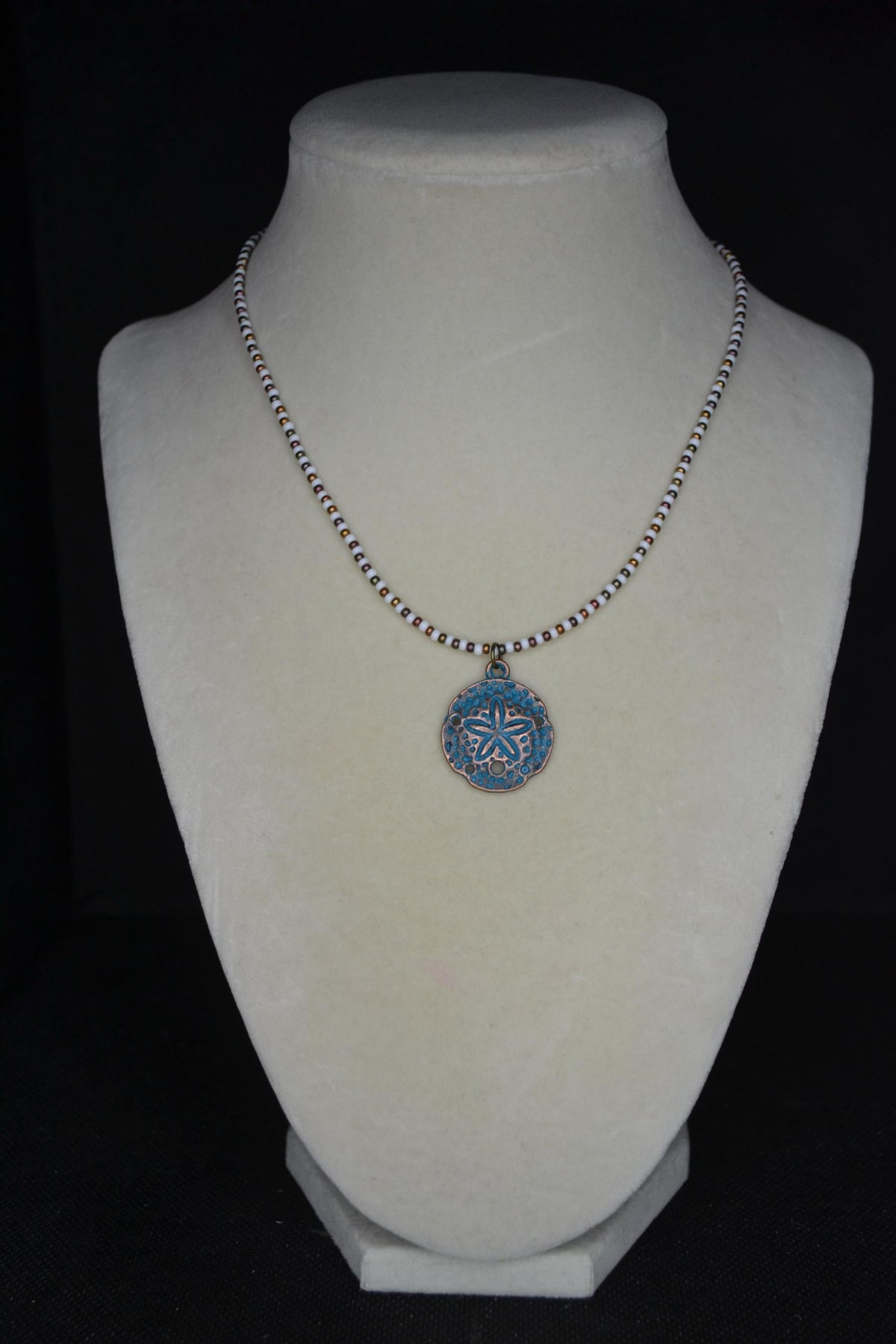 Bronze Sand dollar pendant glass bead necklace. White and bronzes
