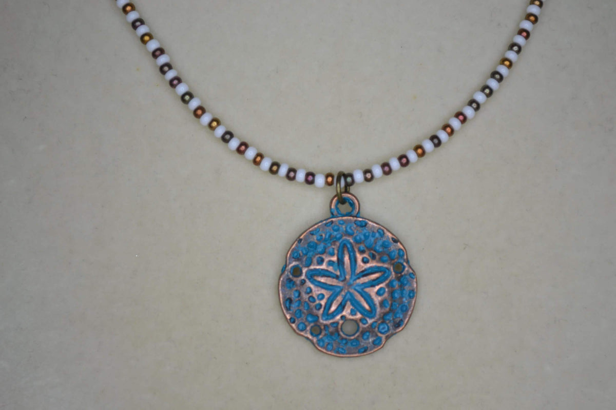 Bronze Sand dollar pendant glass bead necklace. White and bronzes