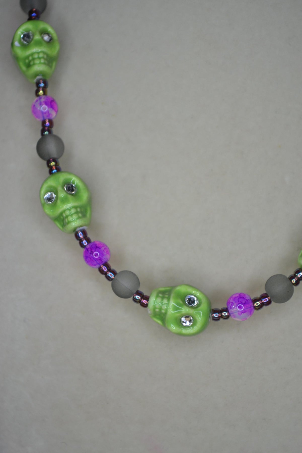 Beaded skull glass necklace. Lime, Fuschia, frosted black, and oil spill