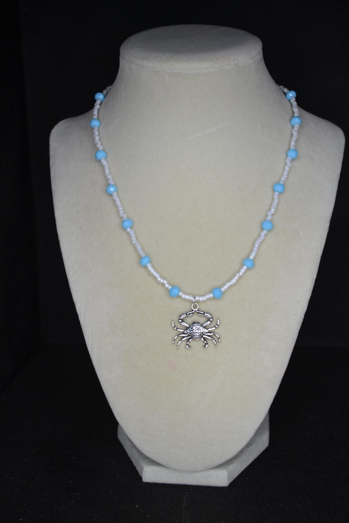 Silver crab pendant glass bead necklace. Blue and white