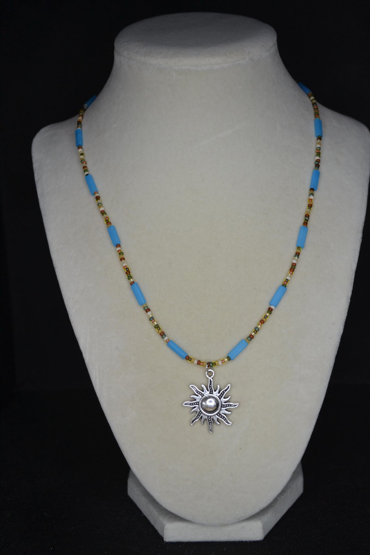 Silver sun pendant glass bead necklace. Matte blue and forest colors