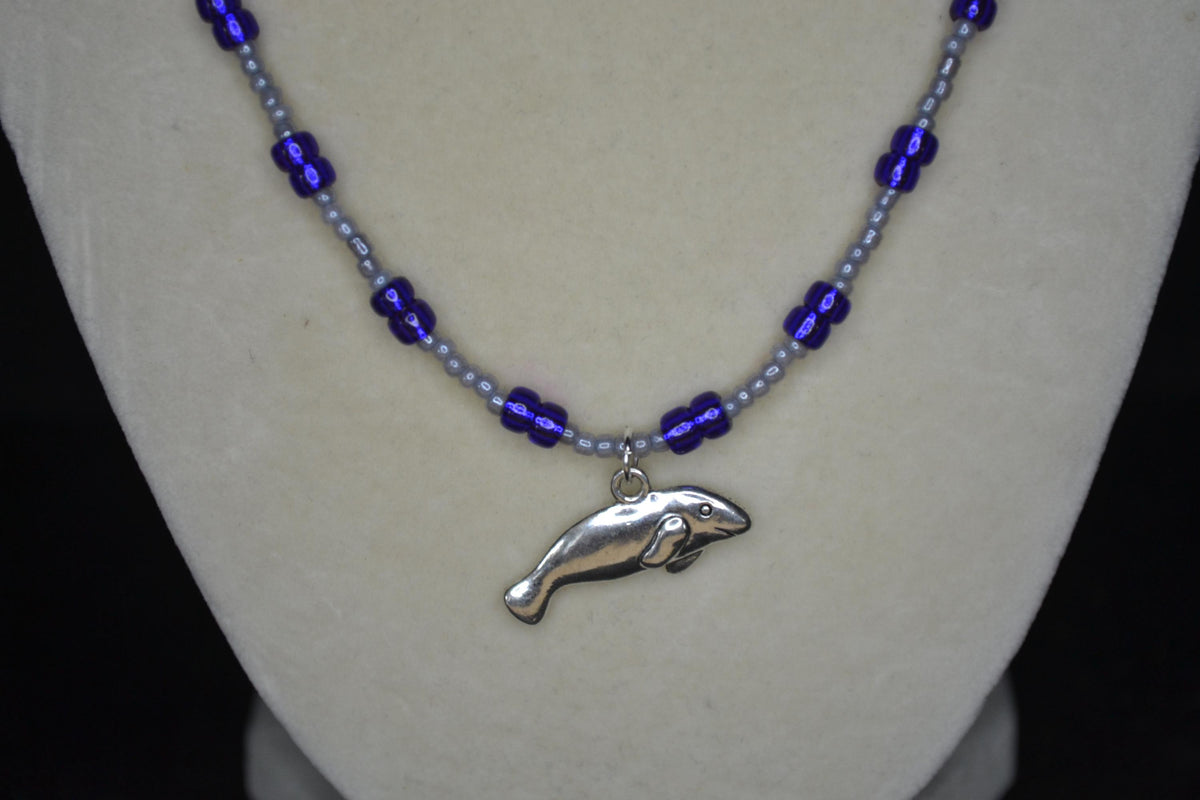 Silver Manatee pendant glass bead necklace. Pearl grey and iridescent indigo