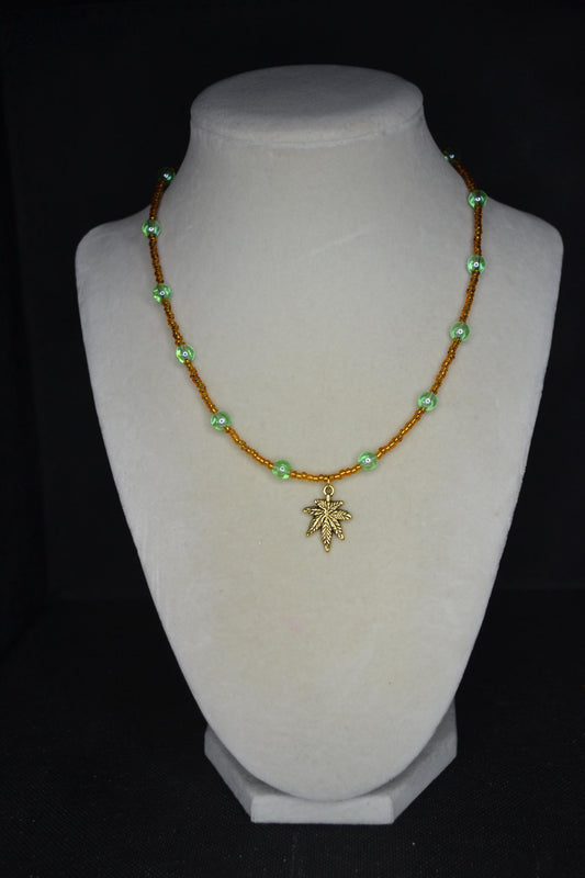 Gold Marijuana Leaf pendant glass bead choker. Brown and green
