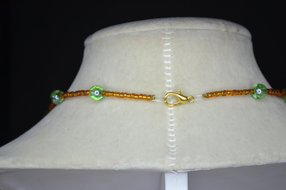 Gold Marijuana Leaf pendant glass bead choker. Brown and green