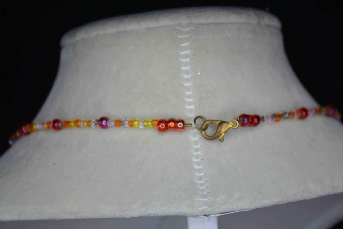 Vintage black cat pendant glass bead choker. Reds and oranges
